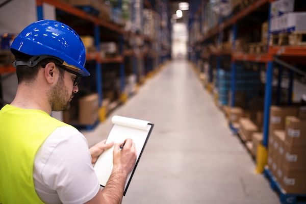 factory-worker-holding-clipboard-checking-inventory